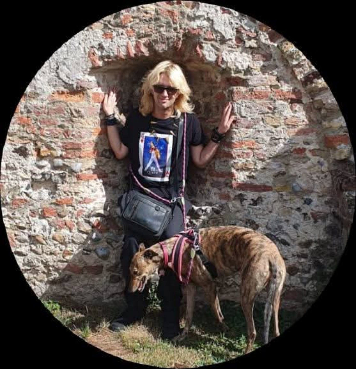 Jack Preston with his dogs in a historic brick archway
